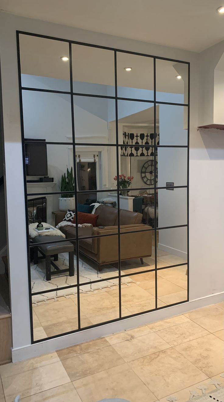 a living room filled with furniture and mirrors