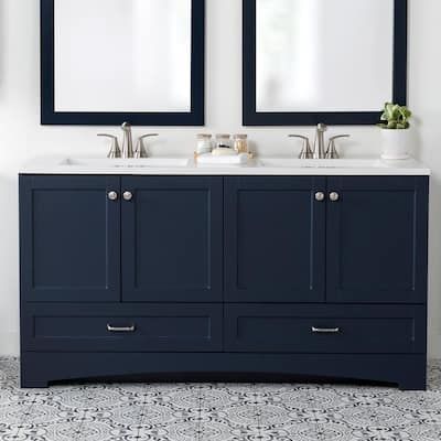 two mirrors are above the double sink vanity in this white and blue bathroom with tile flooring