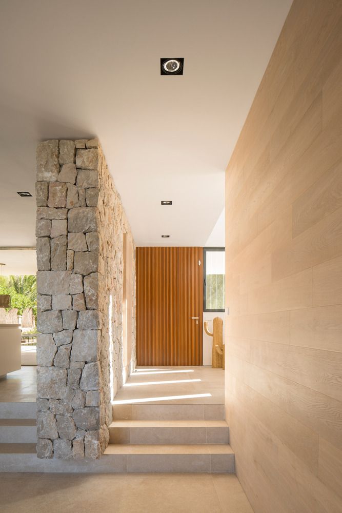 the hallway is lined with stone and wood