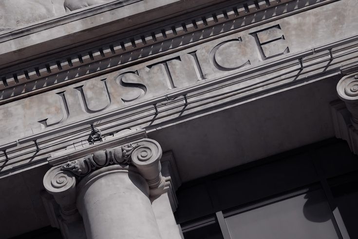 an old building with the word justice written on it's front and side columns