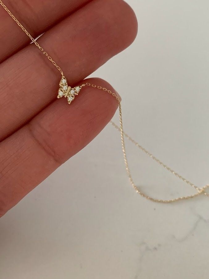 "14K Yellow Gold Gold Butterfly Necklace 16\"+2, Dainty Butterfly Chain, Minimalist Necklace, Layering Necklace, Butterfly Chain, Butterfly ♦ Materials: 14K Yellow Gold, Cubic Zirconia ♦ Available colors: Yellow Gold ♦ Necklace measurements: 16\" with a 2\" extender, for a total length of 18\". The chain is 1MM wide. The charm is 5MM -------------------------------------------------- ♦ -------------------------------------------------- MATERIALS All chains and pendants are made of 14K Solid Gold M Necklaces, Gold Dainty Jewelry, 14k Gold Butterfly Necklace, Dainty Butterfly Necklace, Gold Dainty Necklace, Gold Butterfly Necklace, Necklace Measurements, Butterfly Chain, Gold Minimalist Jewelry