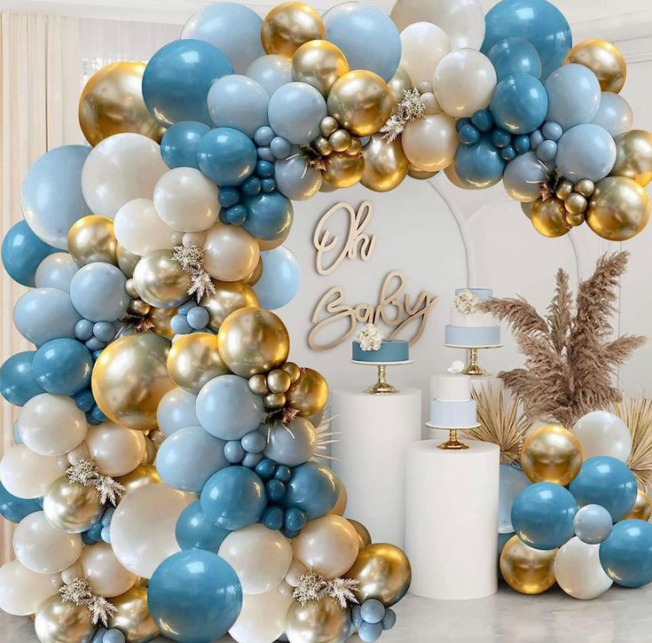 a blue and gold balloon arch for a baby shower