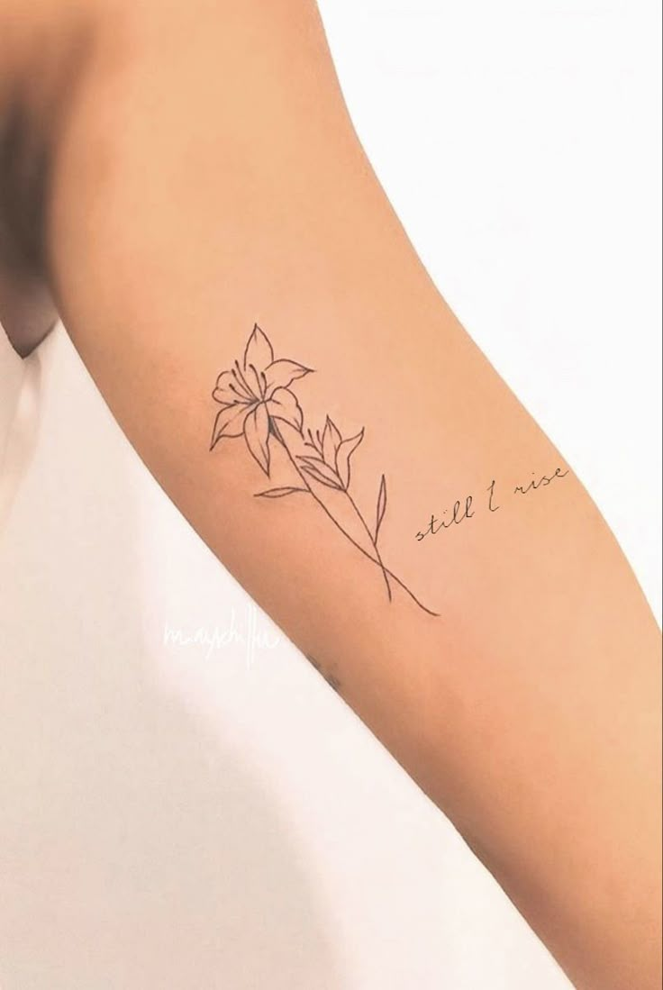 a woman's arm with a flower tattoo on it