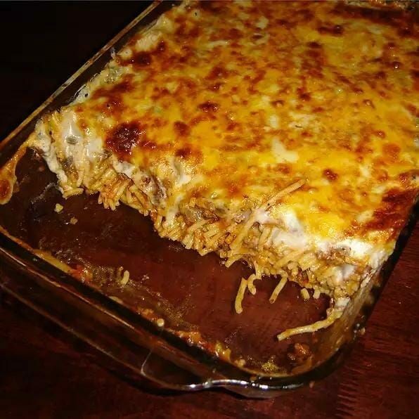 a casserole dish with cheese and meat in it