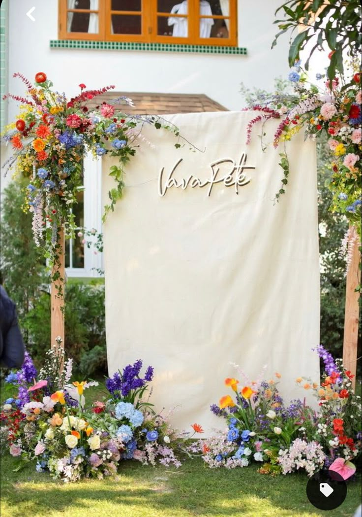 an outdoor ceremony with flowers and greenery on the grass, decorated with a sign that says verabett