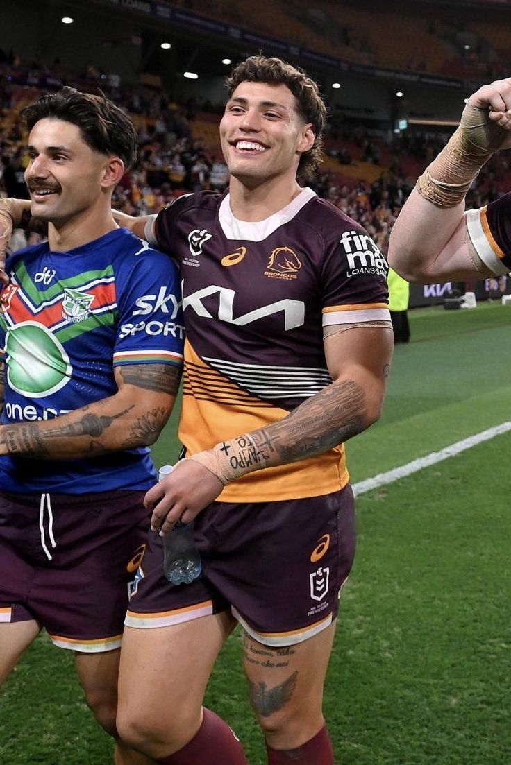 two rugby players are walking off the field after their team's victory over australia