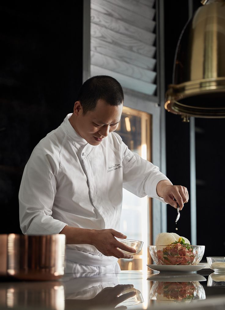 a man is preparing food in the kitchen