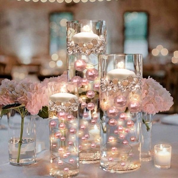 there are candles and flowers in vases on the table