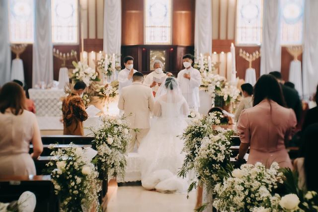 the bride and groom are walking down the aisle