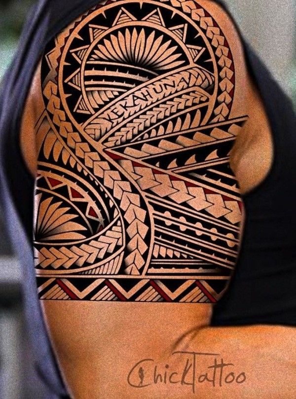 a man's arm with an intricate tattoo on the upper half of his arm