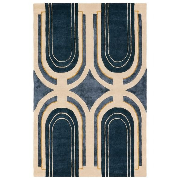 an area rug with blue and beige designs on the front, along with a white background