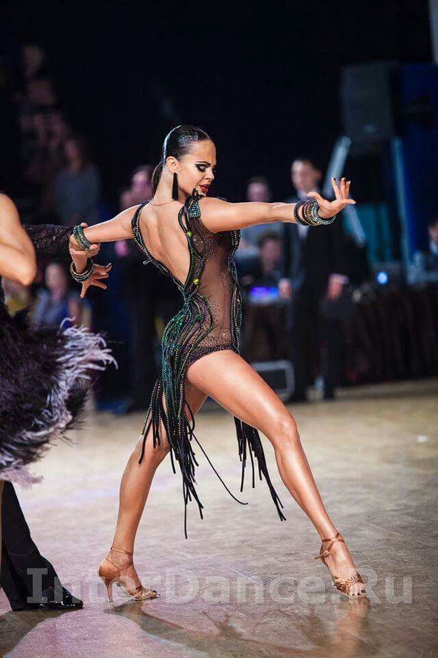 two women in black and green costumes dancing