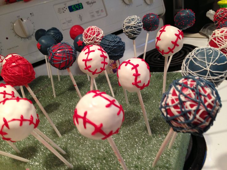 cake pops with red, white and blue frosting are on top of a green tray