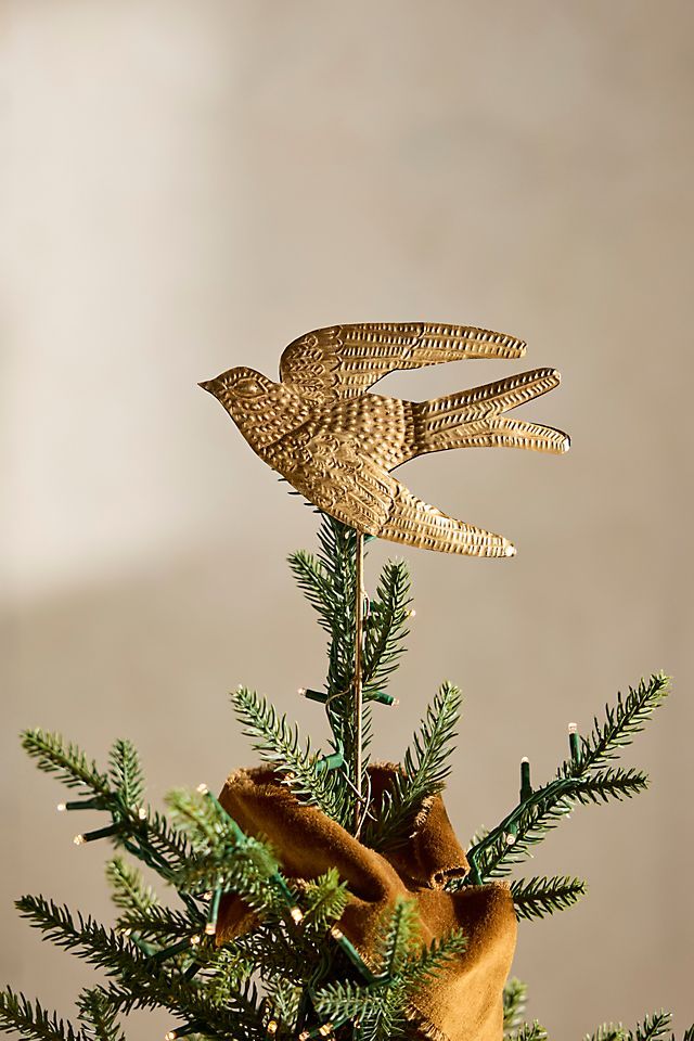 two birds are perched on top of a christmas tree ornament that is decorated with pine cones and evergreen needles