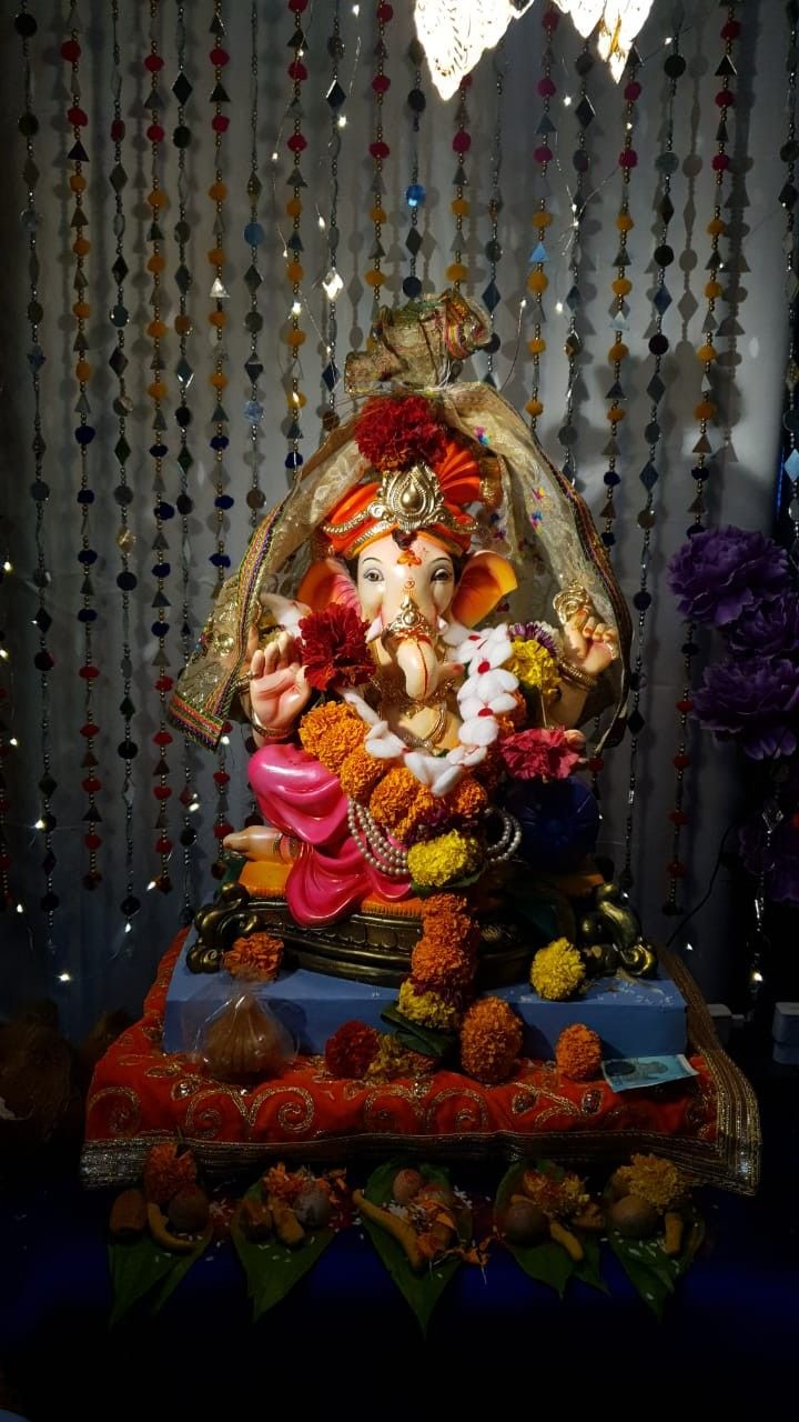 there is a statue of lord ganesh in the middle of some flowers and decorations