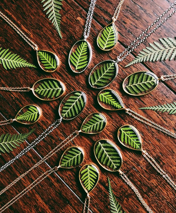 green leaf necklaces on a wooden table