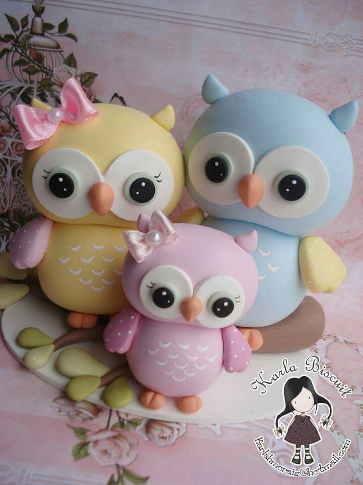 three little owls sitting next to each other on top of a cake covered in frosting