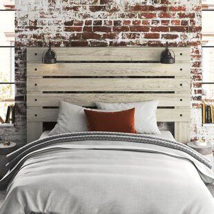 a bedroom with brick walls and wooden headboard, made to look like an old fashioned bed