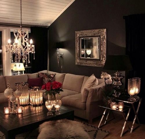 a living room filled with lots of furniture and candles on top of it's coffee table