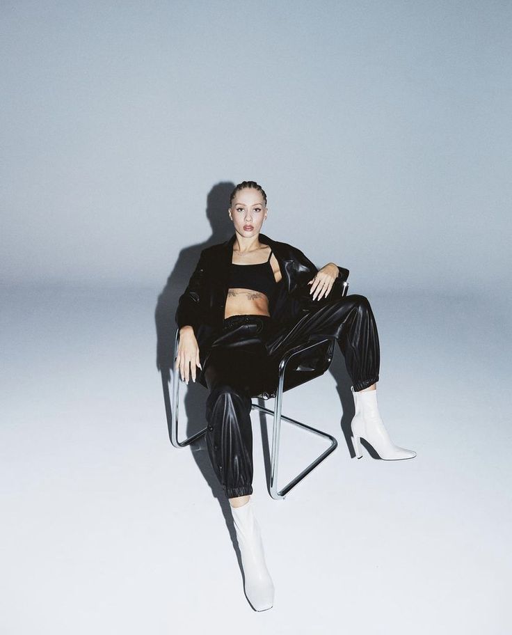 a woman sitting in a chair with her legs crossed