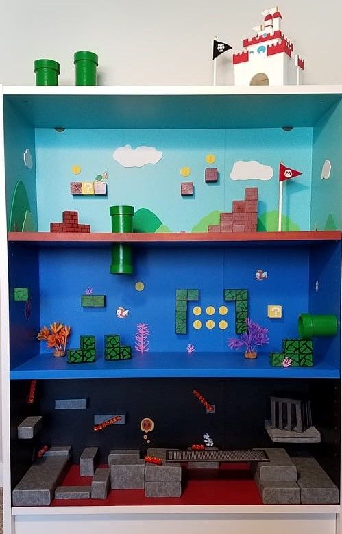 a shelf with some legos on it in front of a blue wall and red floor