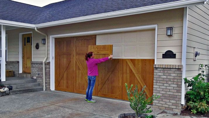 a woman is opening the garage door on her house