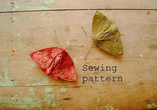 two different colored moths sitting next to each other on top of a wooden surface with the words sewing pattern below them