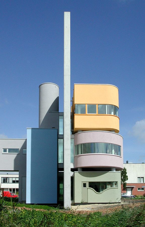 an unusual building in the middle of a grassy area