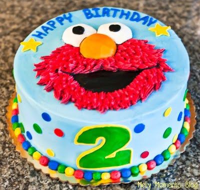 a blue birthday cake with an elmo face and number two on it's top