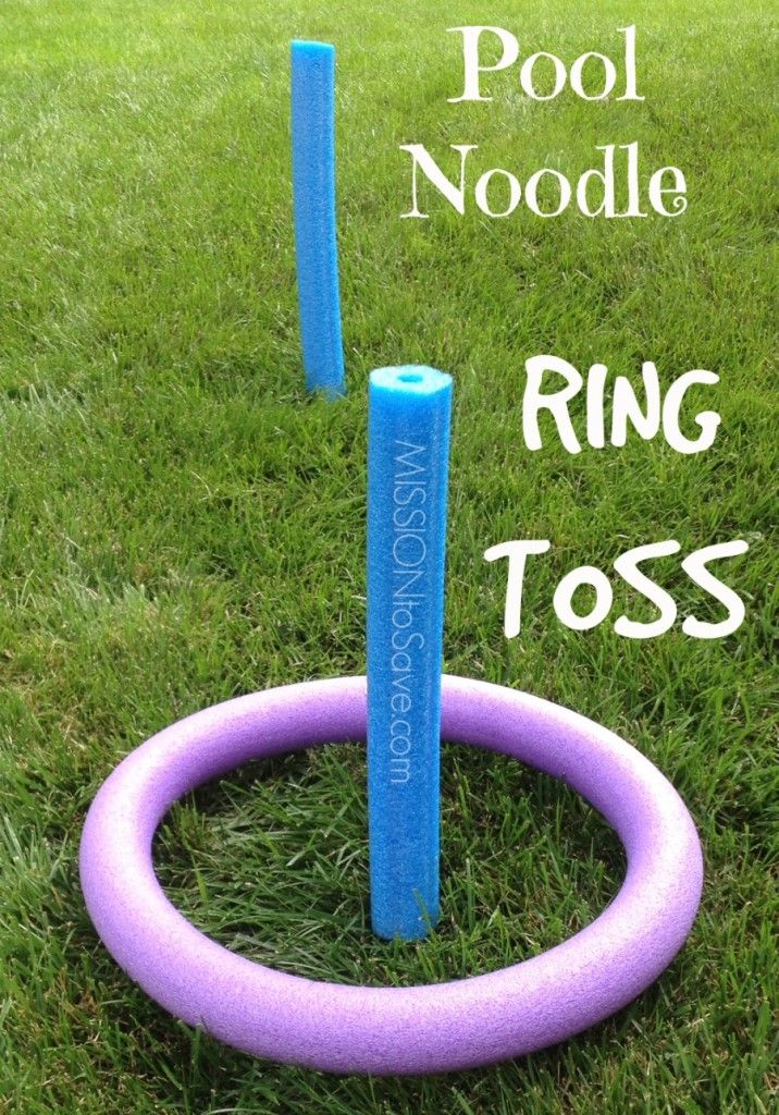 an inflatable pool noodle ring toss game on the grass with purple rings