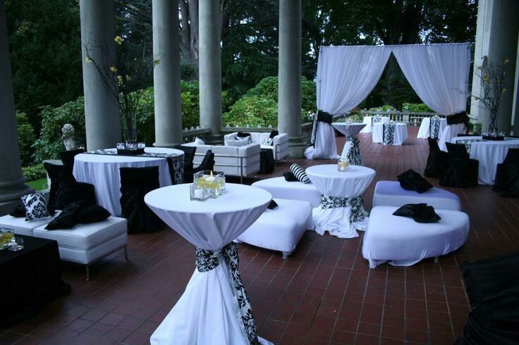 an outdoor wedding venue with white and black decor