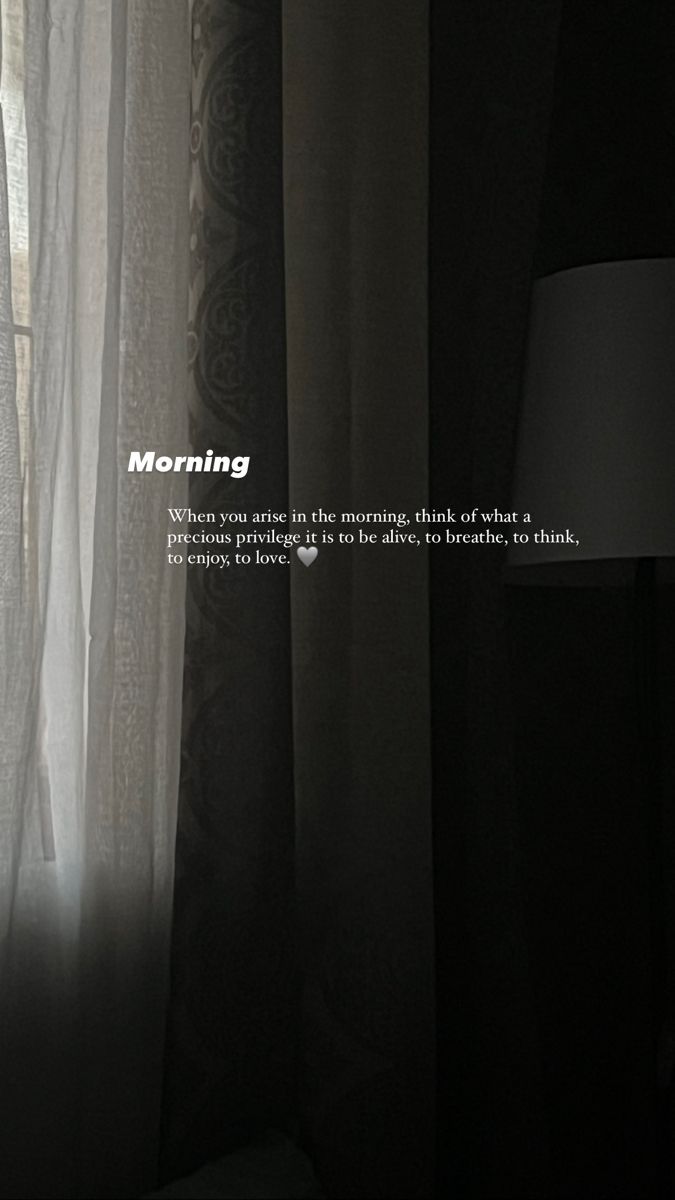 a window with curtains and the words morning written in white on it, next to a lamp