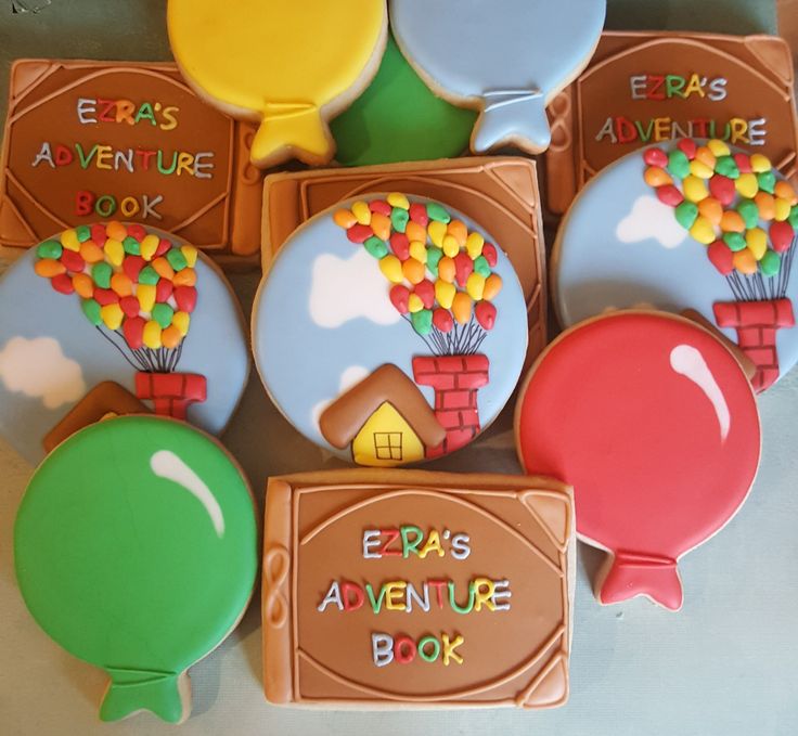 there are many decorated cookies in the shape of hot air balloons and books on display