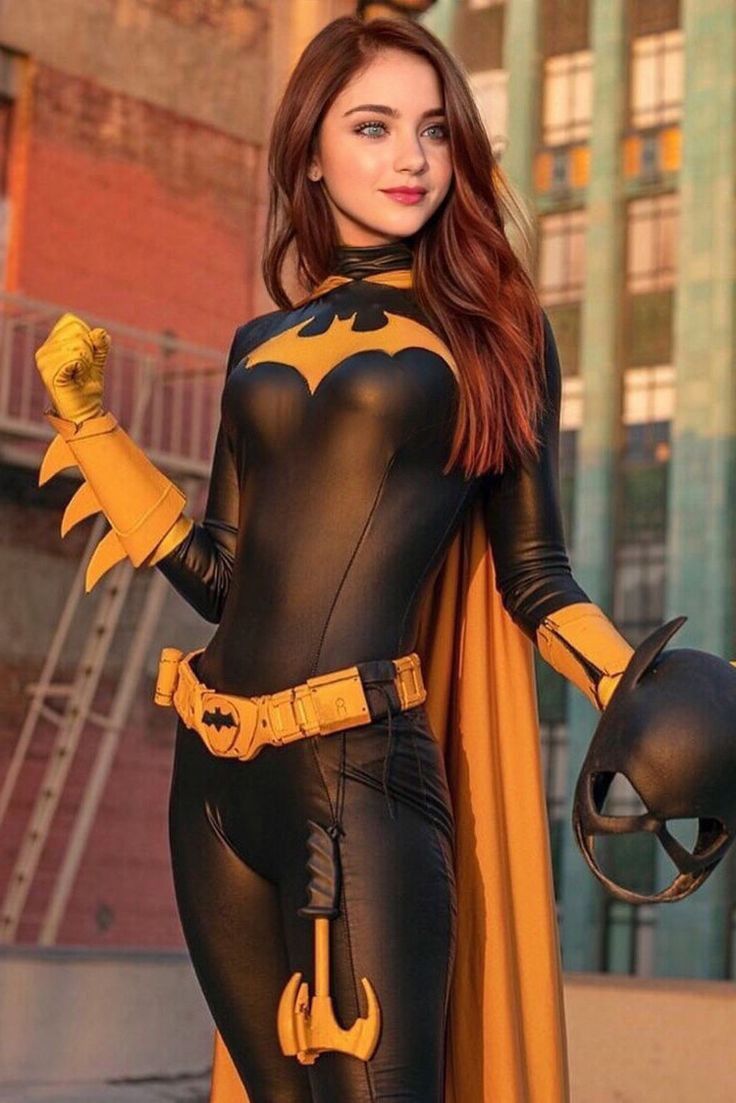 a woman dressed as batgirl posing for the camera