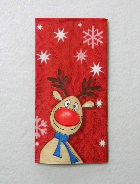 a red and white christmas card with a reindeer on it's head, surrounded by snowflakes