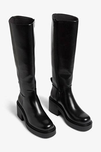 Chunky heeled black faux leather knee-high boots - Black - Monki WW Chunky Black Boots Heels, Leather Knee High Lug Sole Boots, Shop Knee High Black Boots, Chunky Heel Fall Boots, Boots Womens Black, Tall Chunky Flat Boots, Knee High Plateau Boots, Black Boots Lyst, Black Pu Boots