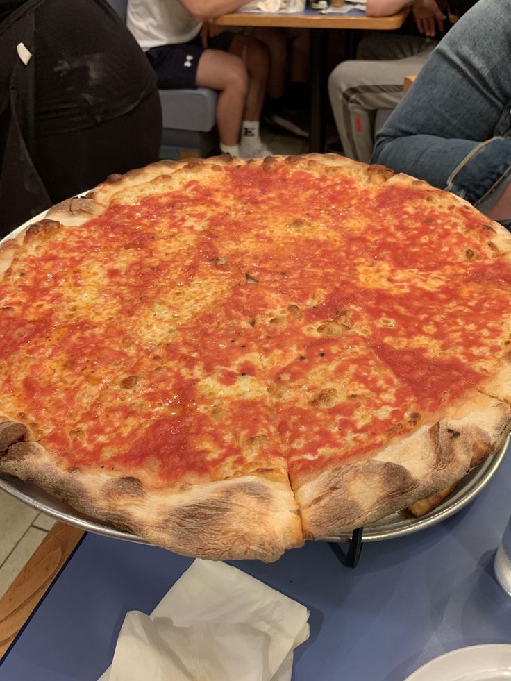 a large pizza sitting on top of a metal pan