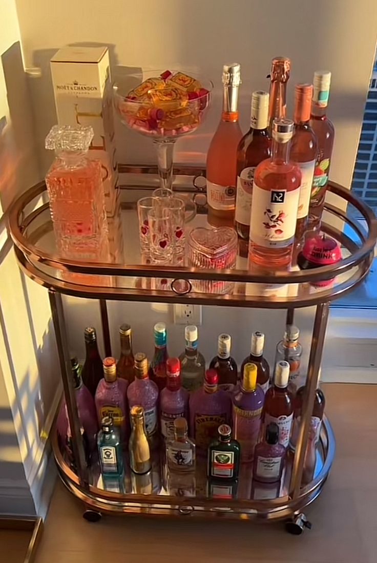 a bar cart filled with liquor bottles and glasses