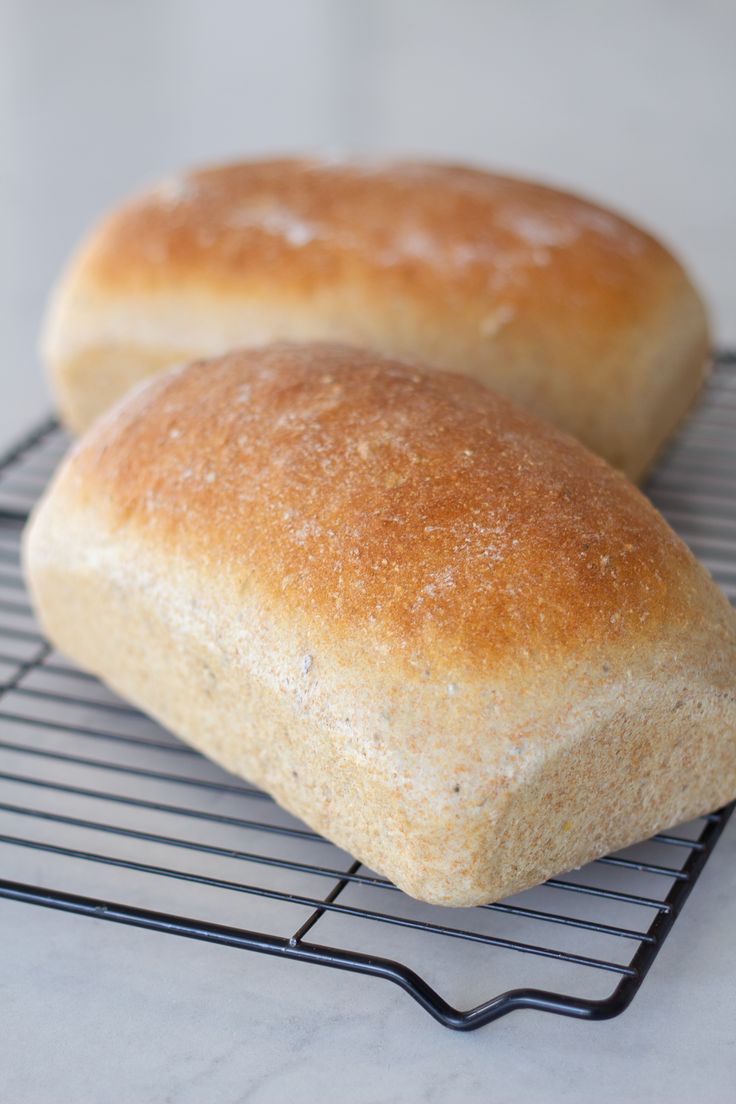 two loaves of bread sitting on a cooling rack