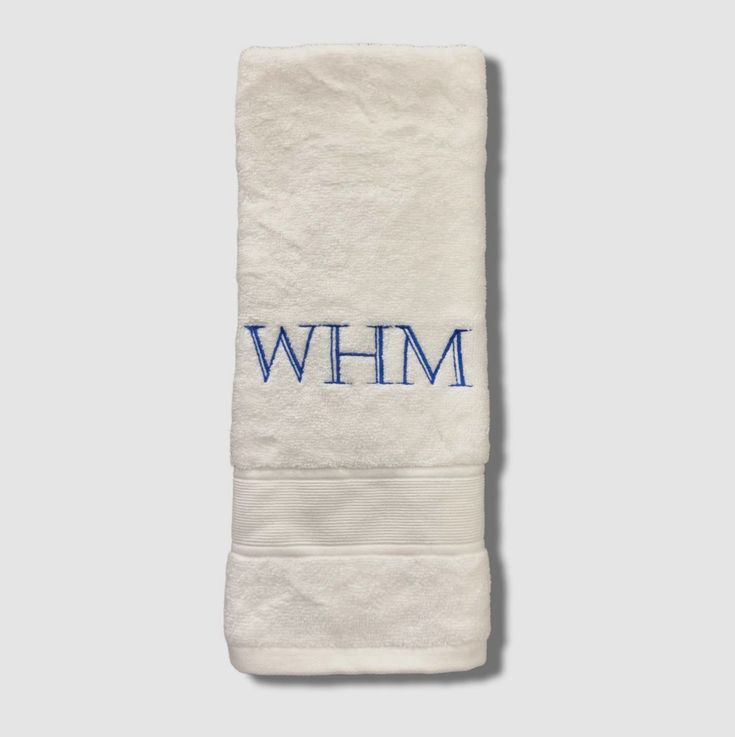 a white towel with the word whm in blue ink on it's side