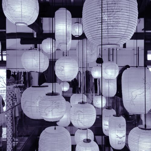 many white paper lanterns hanging from the ceiling