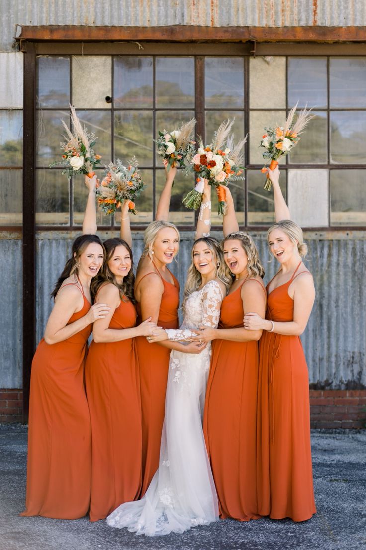 the bride and her bridesmaids are holding up their bouquets