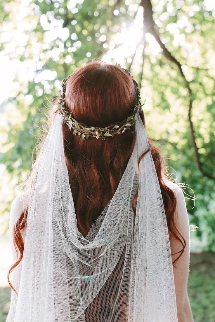 a woman with red hair wearing a veil