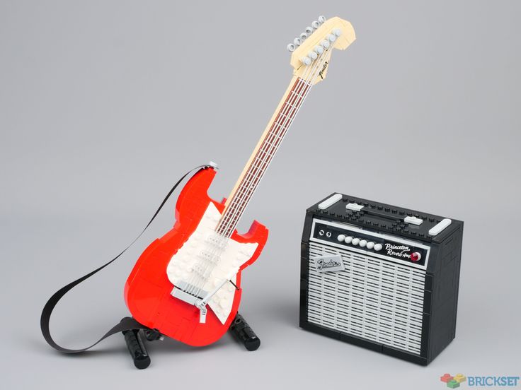 a red guitar and amp sitting next to each other