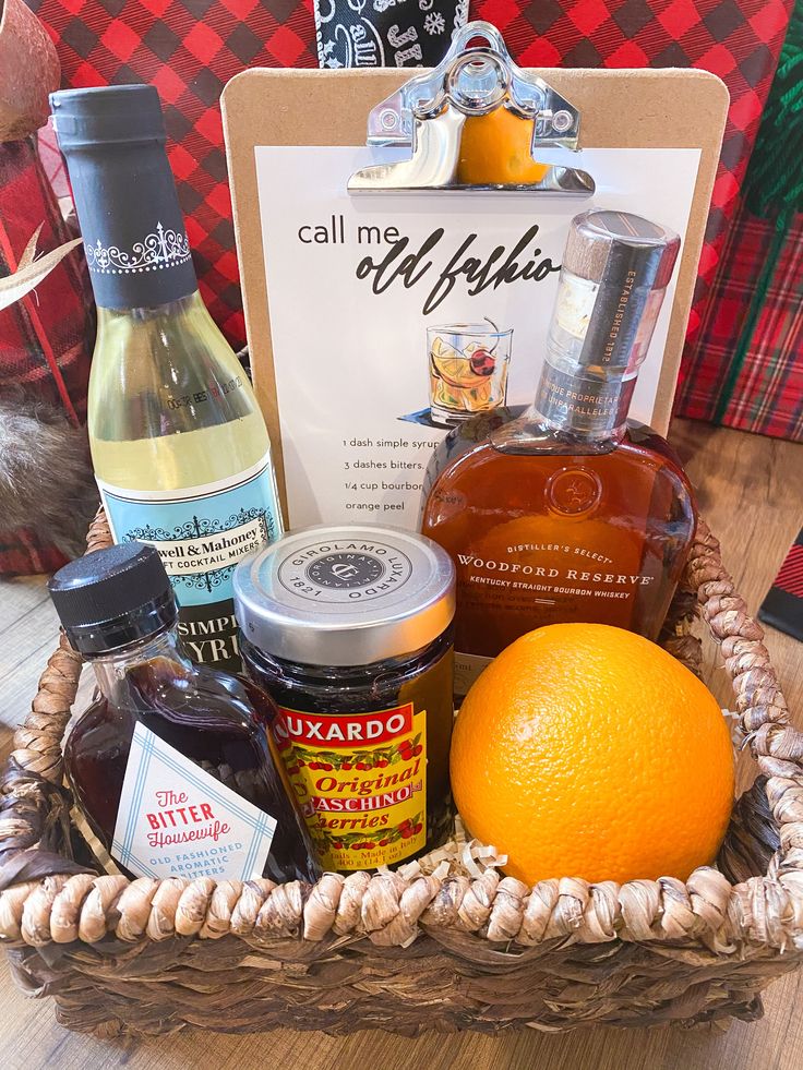 an orange sitting in a basket next to bottles of liquor and other condiments