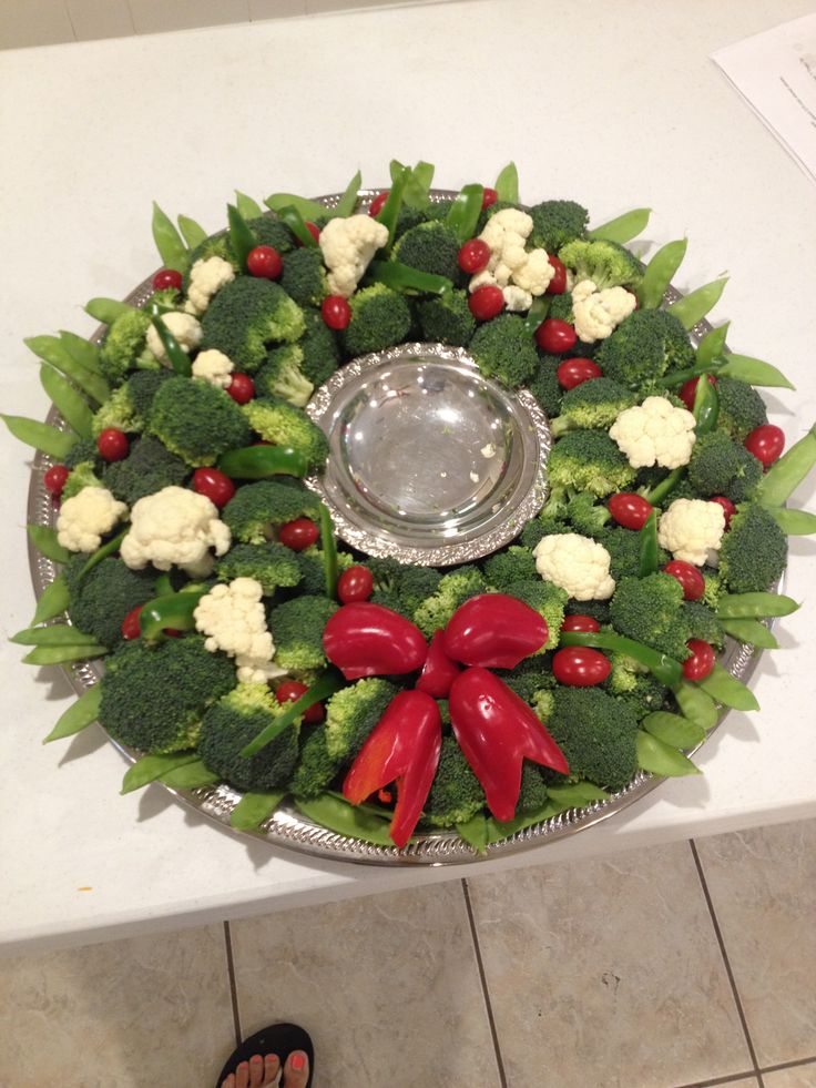 a platter with broccoli, cauliflower and other vegetables on it