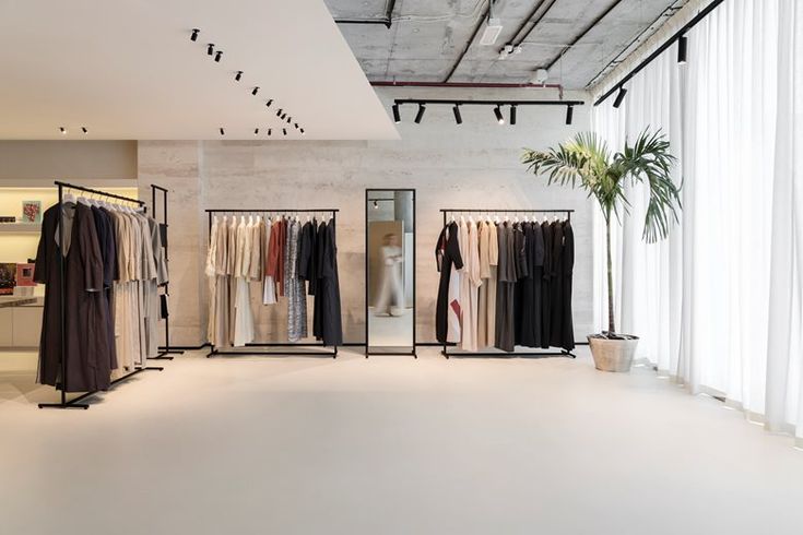 an empty clothing store with clothes on racks