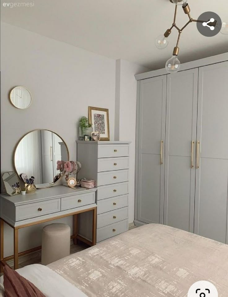 a bedroom with a bed, dresser and large mirror on the wall next to it