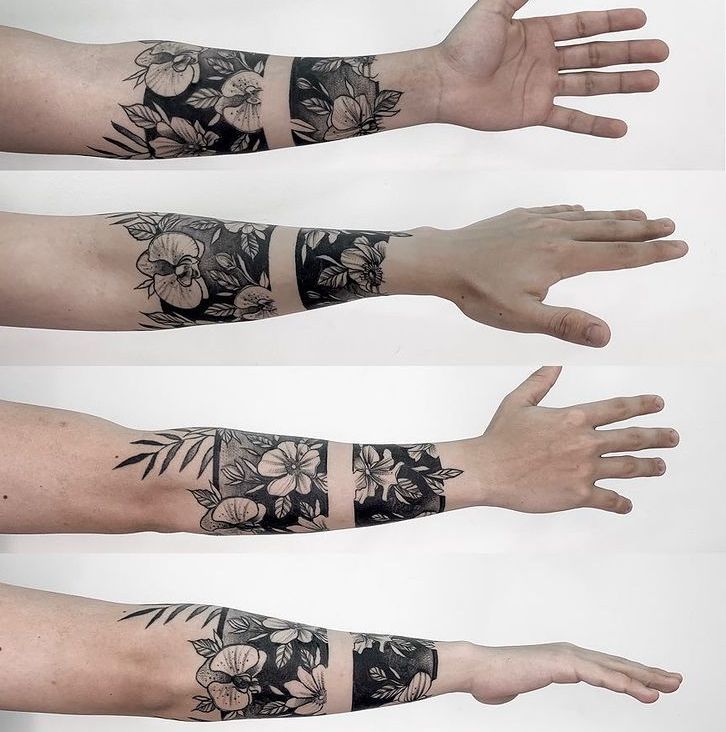 three different tattoos on both arms and hands, one is black and white with flowers