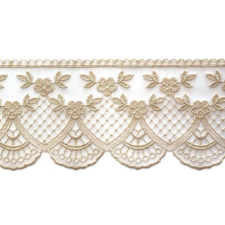 a white lace with gold flowers and leaves on the edge is shown in front of a white background